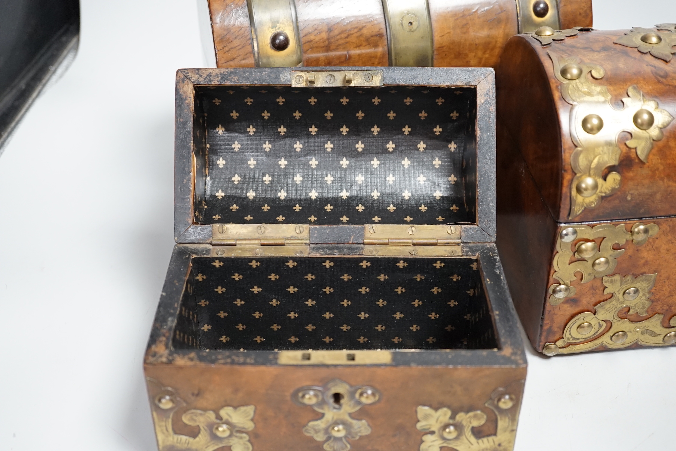 Three Victorian walnut domed topped and brass mounted caskets, largest 23cm wide x 17cm high